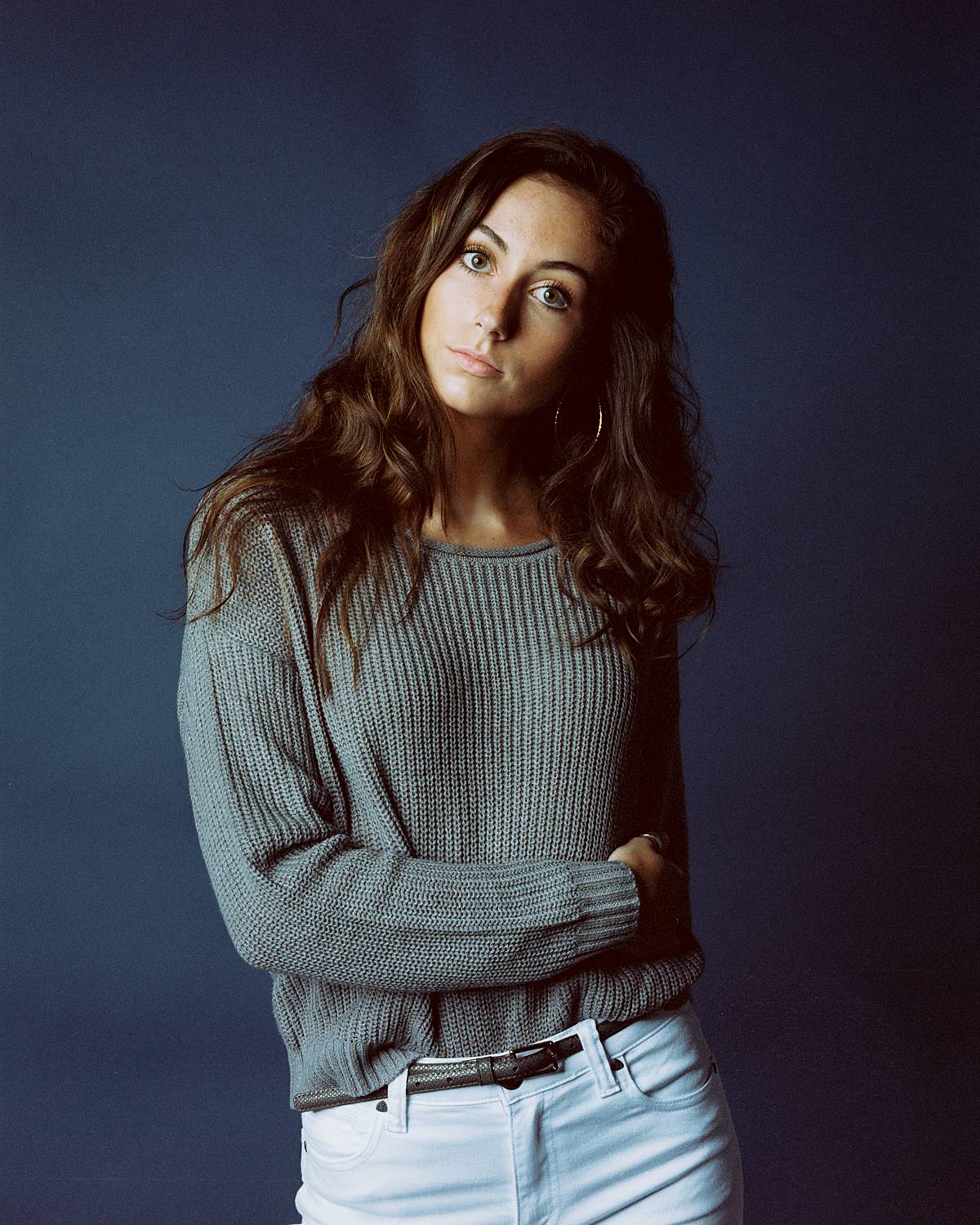 studio portrait of girl in white jeans against savage universal ultramarine seamless paper backdrop shot on kodak Portra 160vc film and contax 645