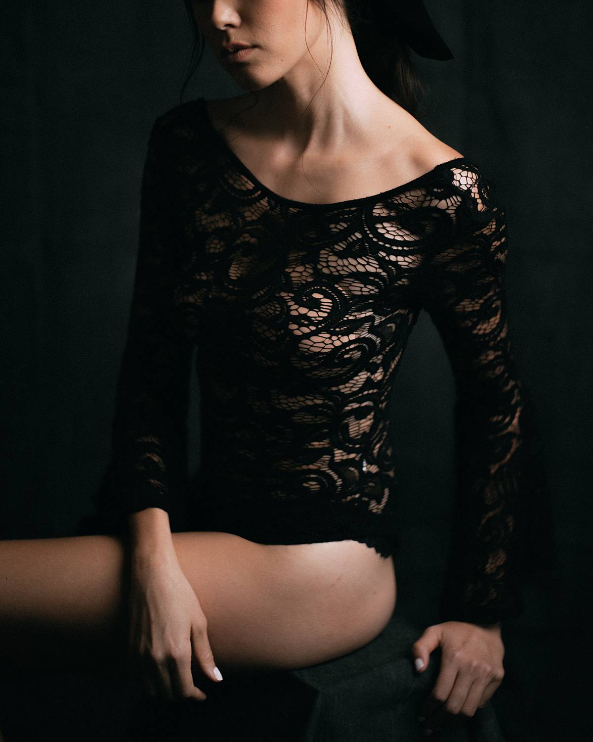 charleston studio boudoir with rembrandt lighting and grey muslin backdrop with bride in black lace longsleeve bodysuit