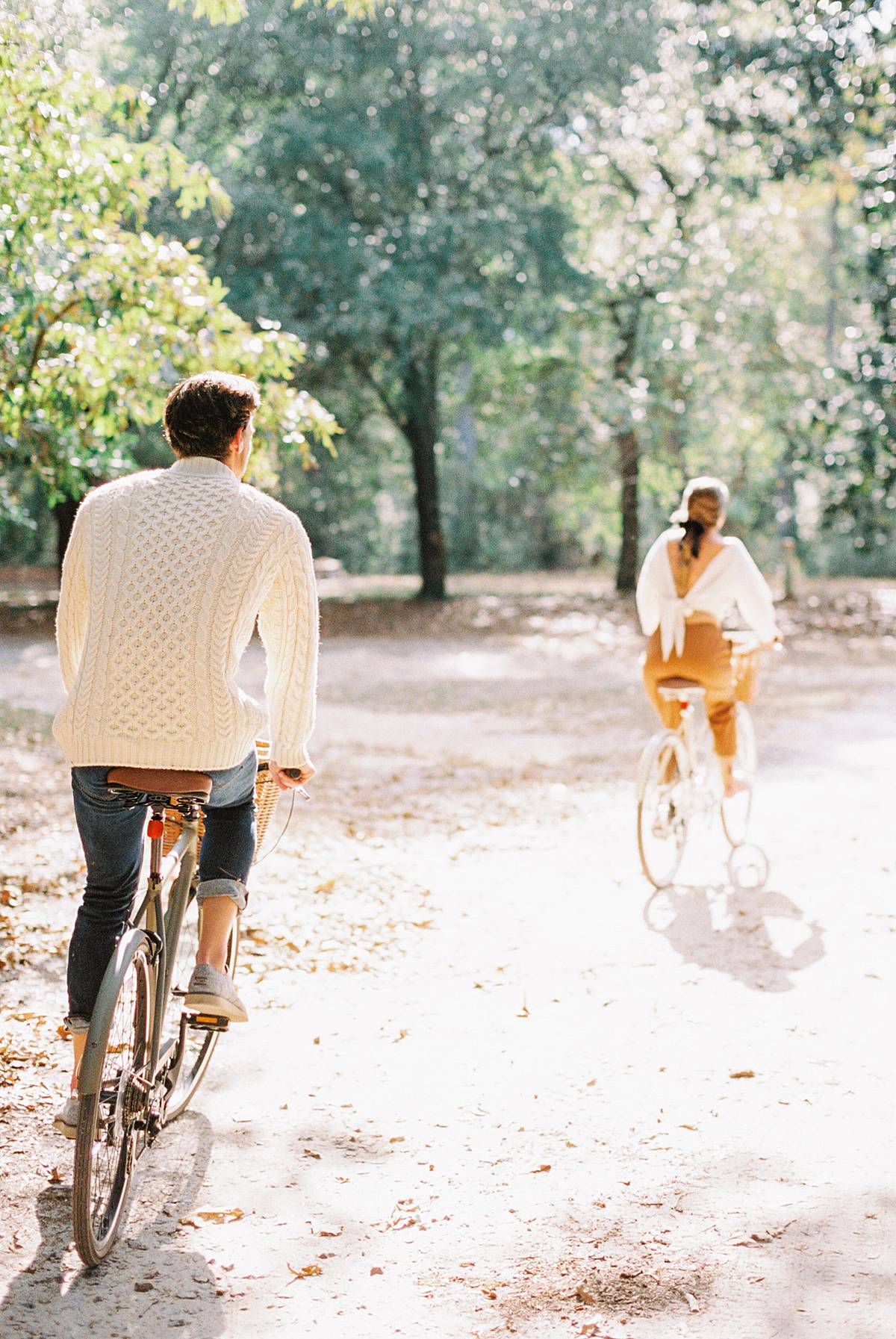 couple riding bikes on dirt road for documentary micro wedding and elopement photograph in south carolina