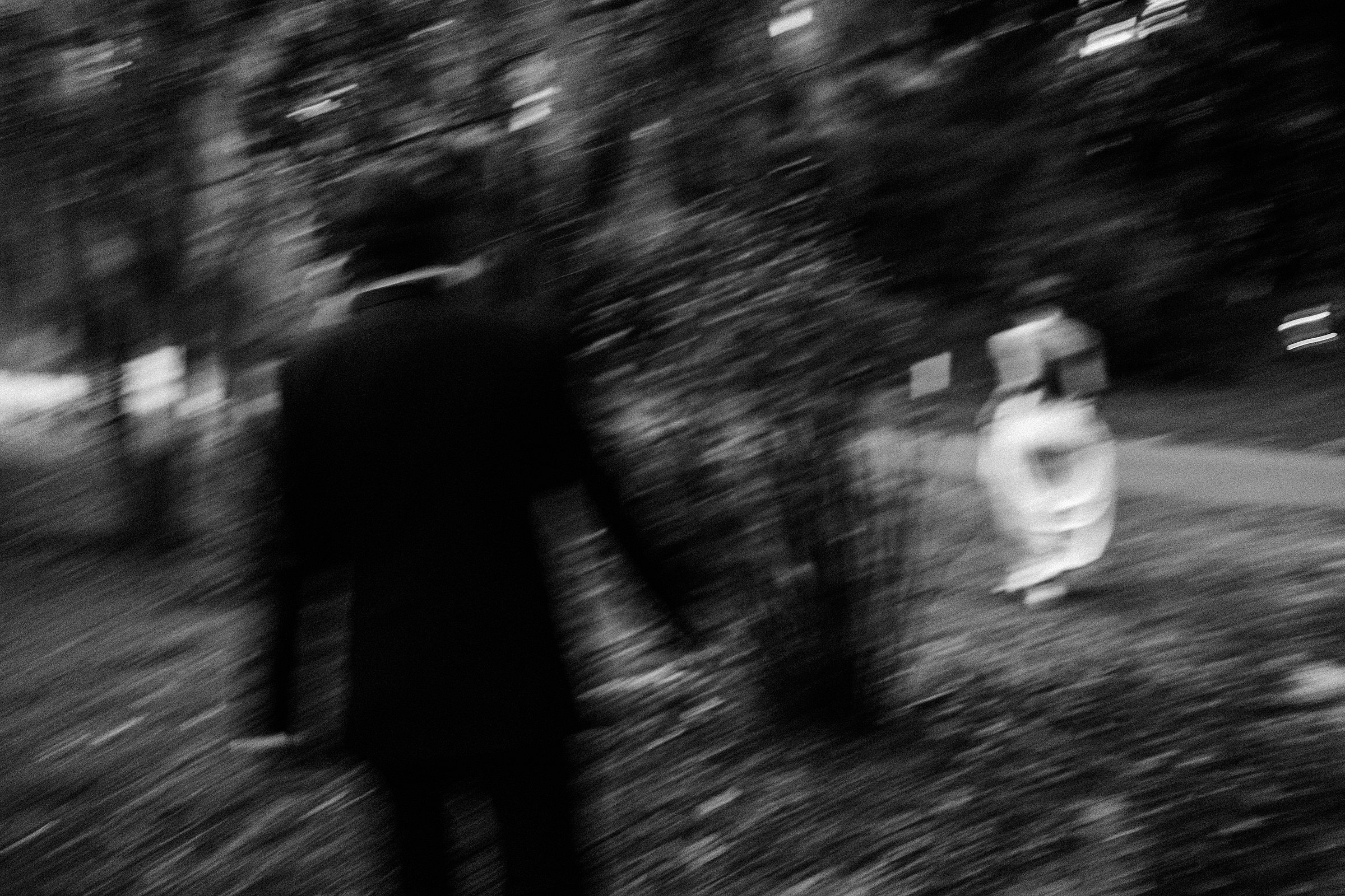 blurry black and white image of bride and groom walking at charleston sc wedding at legare waring house