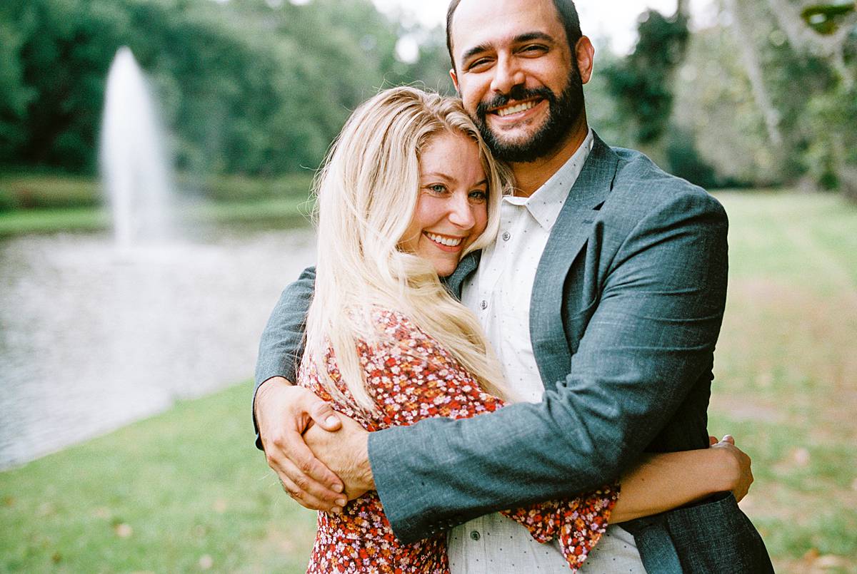 charleston engagement session at middleton place on 35mm film with bride in red sun dress and groom in blazerin 