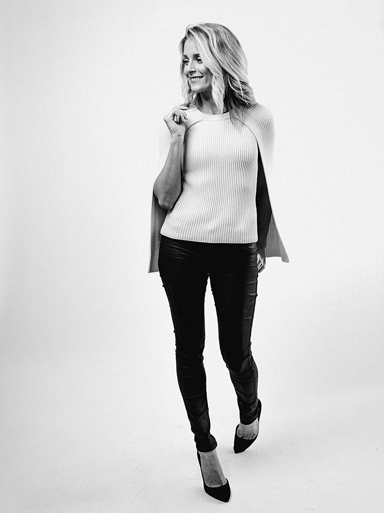 branding portrait in studio with charleston sc wedding planner with black and white re-brand style with black pants and cream sweater