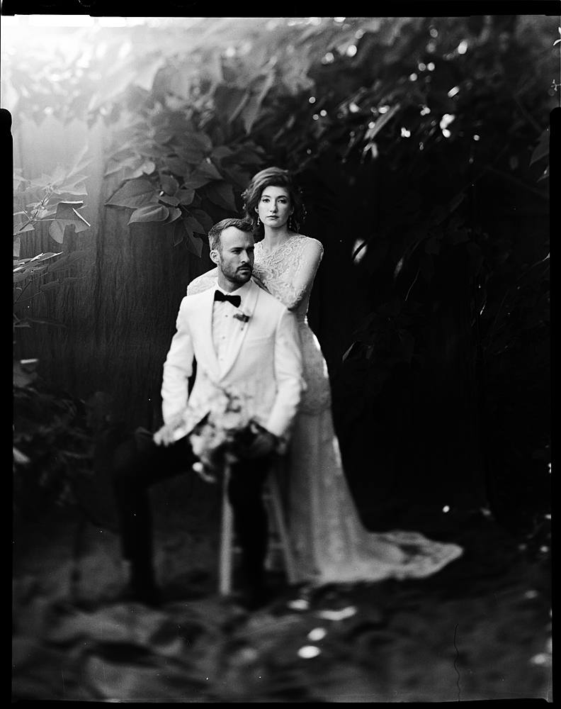 large format black and white film portrait of bride and groom in charleston sc outdoor studio backdrop