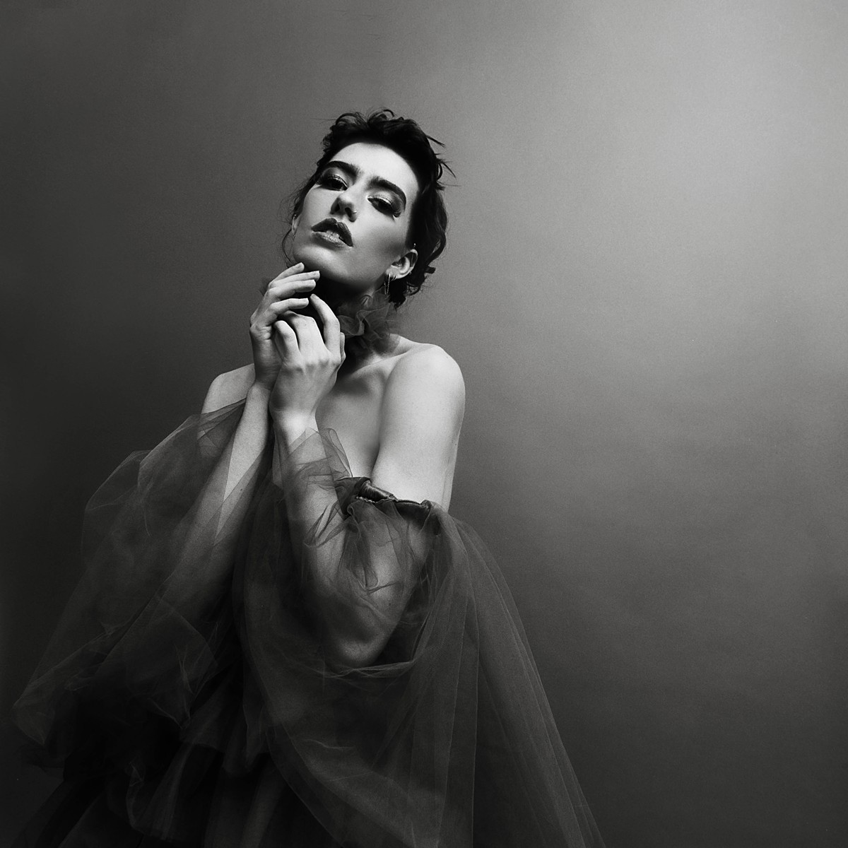 Classic studio fashion editorial on black and white film with a tulle dress
