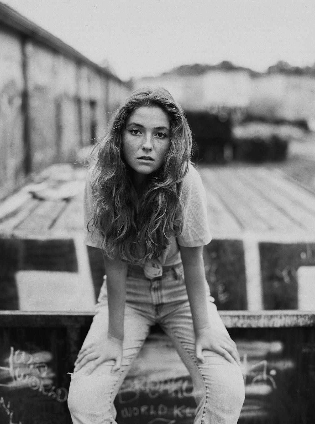 shallow depth of field black and white film portrait of girl in vintage clothes with contax 645