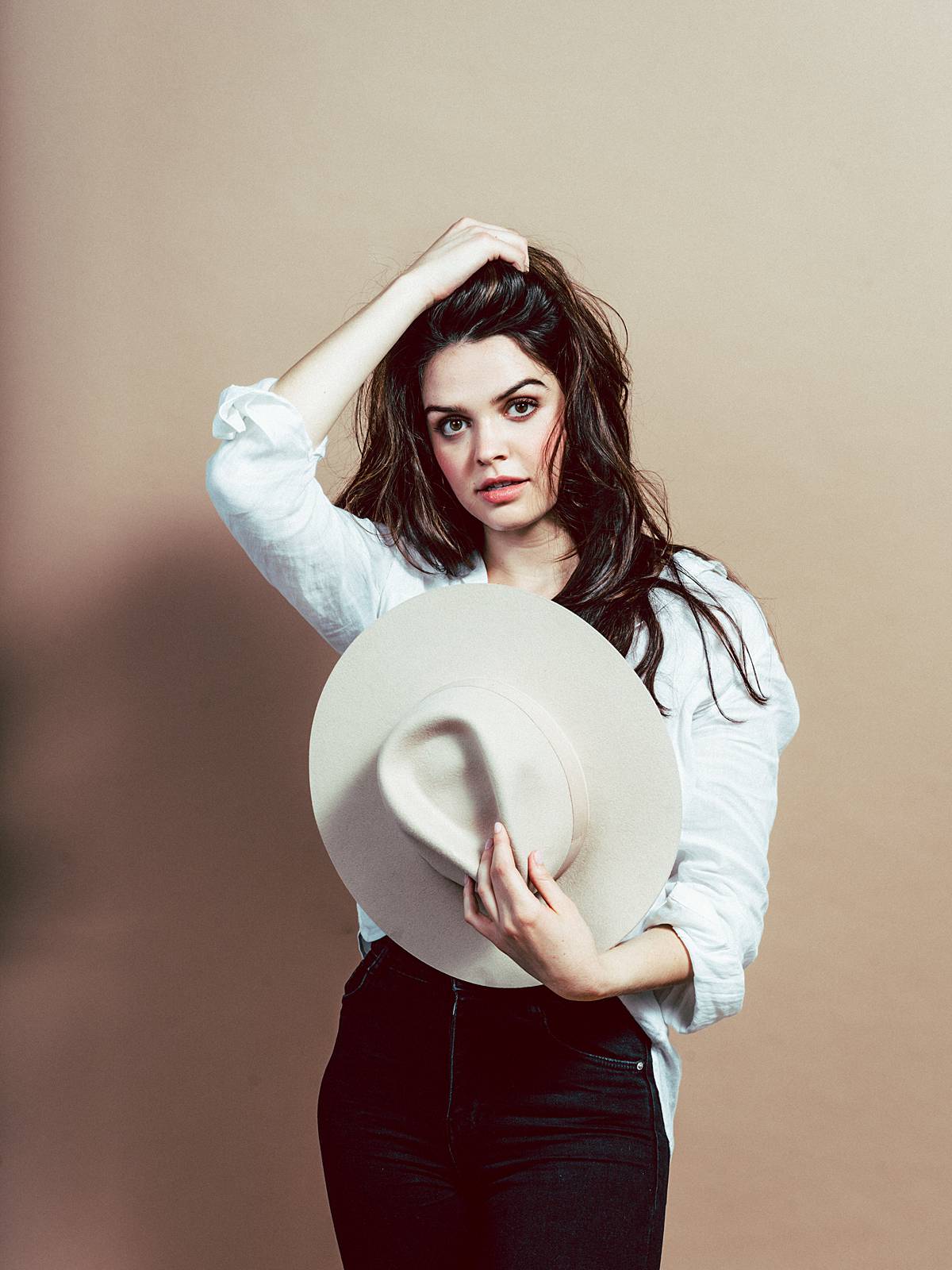 studio editorial portrait on film with contax 645 and girl wearign tan hat white blouse and black jeans 