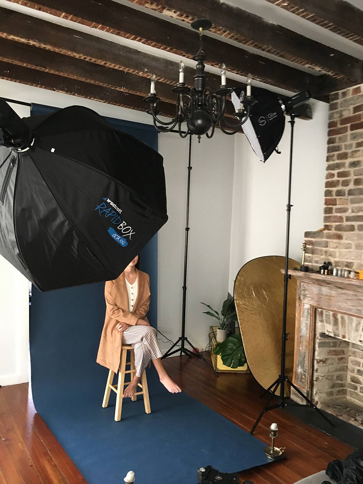 rembrandt lighting pattern with godox studio strobes and girl sitting against savage seamless paper backdrop