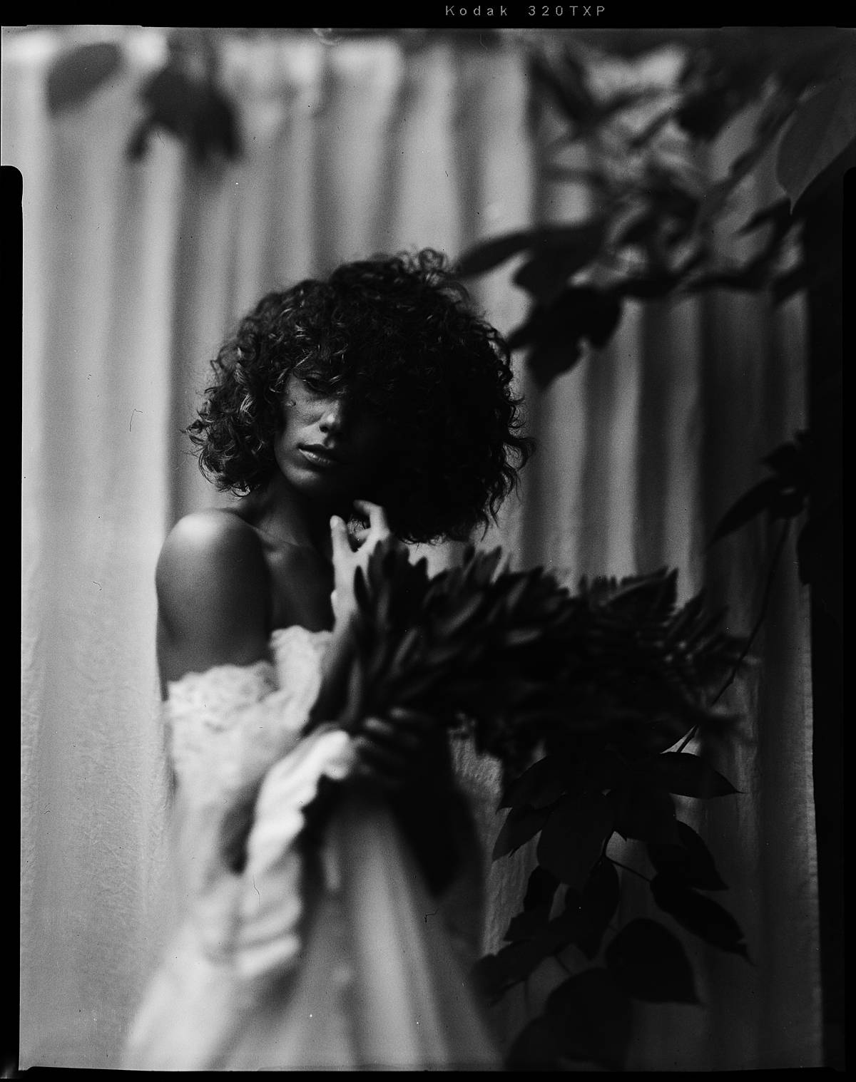 large format black and white film portrait of bride in white sleeve wedding dress in charleston sc with intrepid mkiii 4x5 camera
