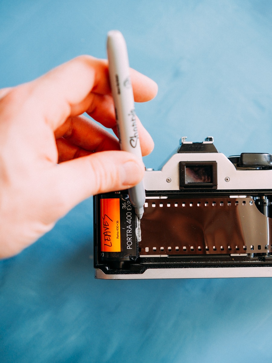 marking 35mm film canister in camera for twice shot double exposed roll with sharpie