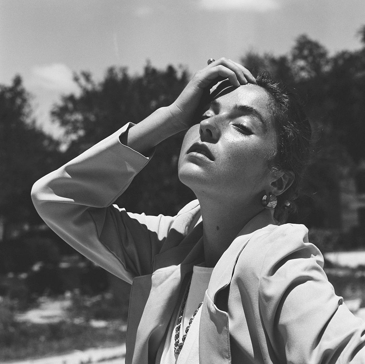 charleston sc fashion editorial portrait on black and white film of girl in womens blazer in dramatic sun
