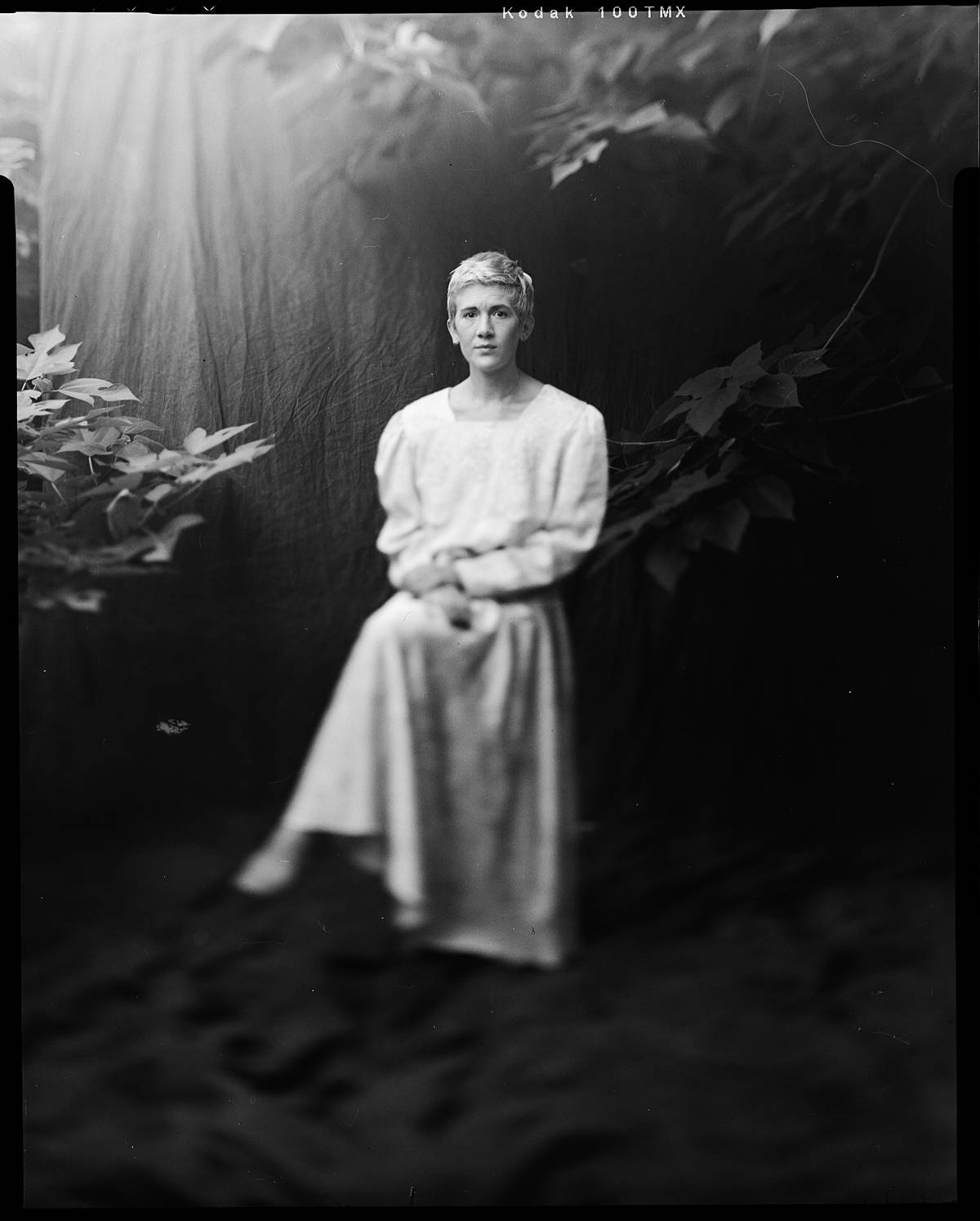 large format film portrait on kodak t-max 100 black and white film in front of outdoor muslin backdrop in charleston south carolina home developed