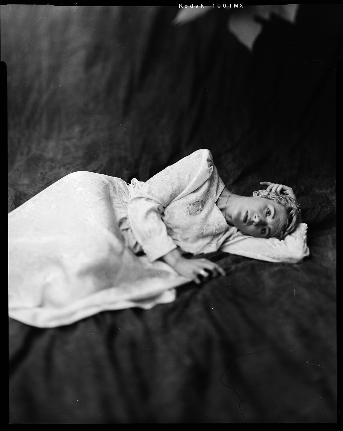 large format film portrait on kodak t-max 100 black and white 4x5 sheet film in charleston sc of girl on backdrop in vintage dress