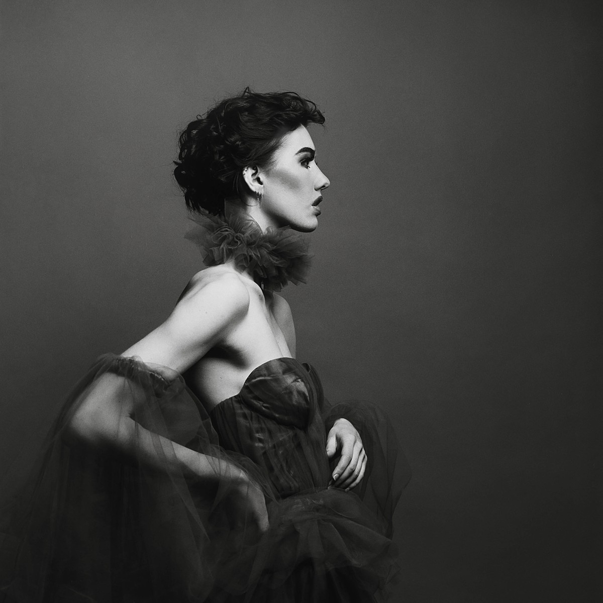 Classic studio fashion editorial on black and white film with a tulle dress