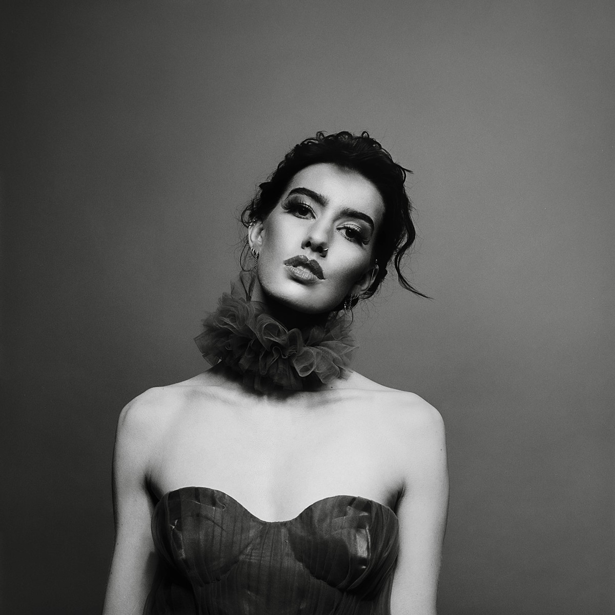 Classic studio fashion editorial on black and white film with a tulle dress