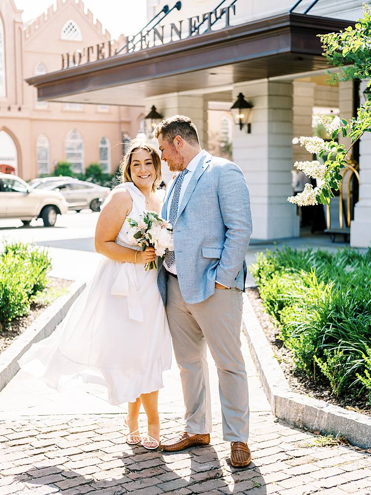 35mm film portrait of bride and groom in front of charleston sc wedding venue hotel bennett