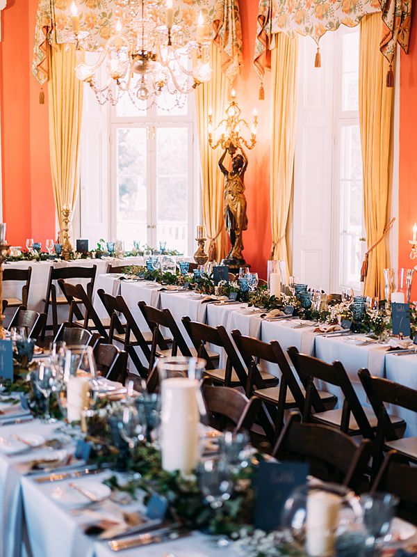 pink room interior of long wedding tables set up for dinner inside at the william aiken house in charleston south carolina