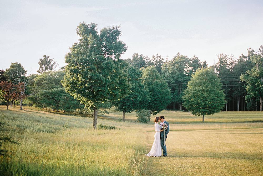 felt mansion wedding portrait on 35mm film by michigan wedding photographer brian d smith of couple in golden field