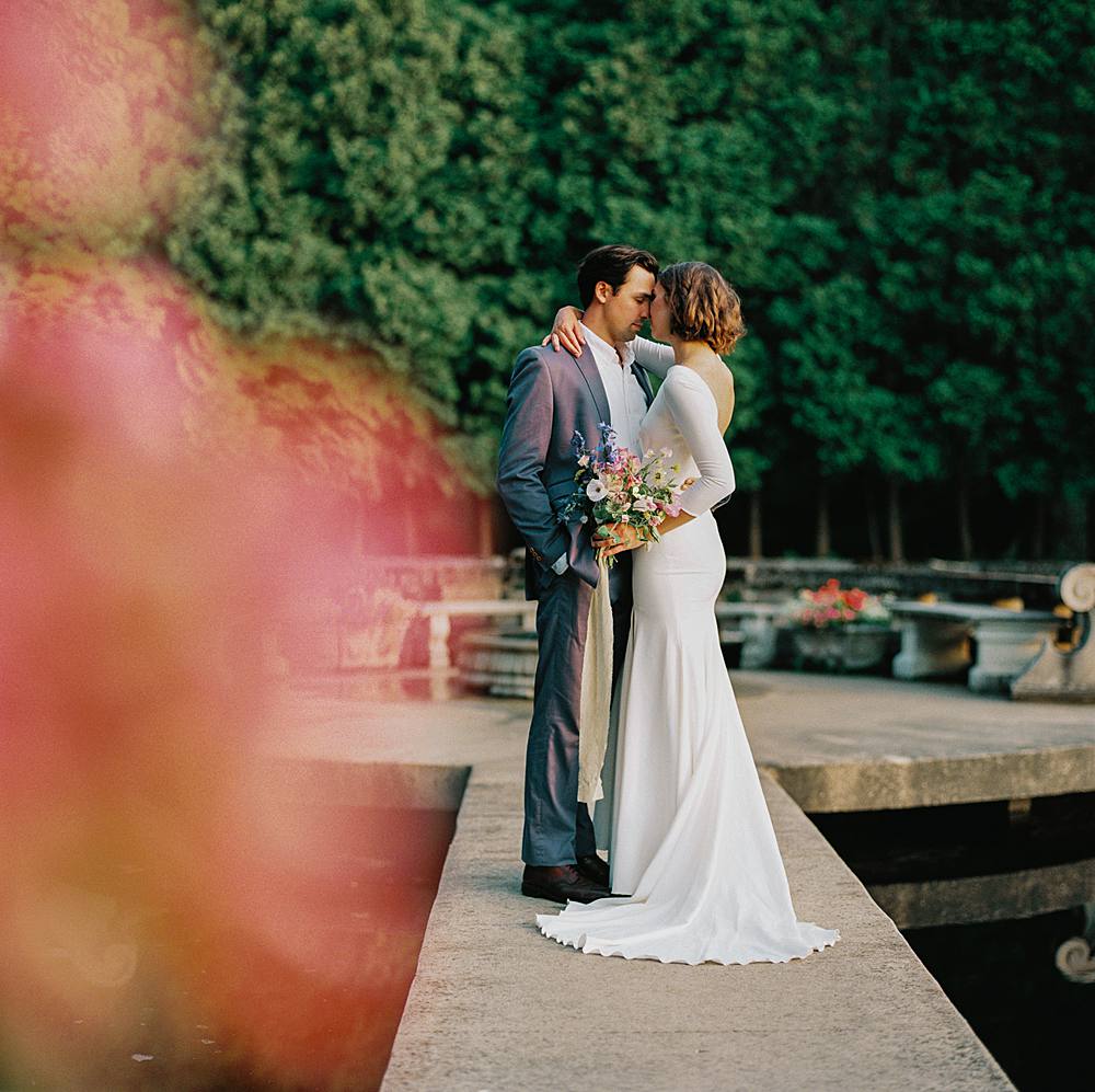 wedding ceremony location at felt mansion in west michigan of bride and groom on medium format film with pink flowers