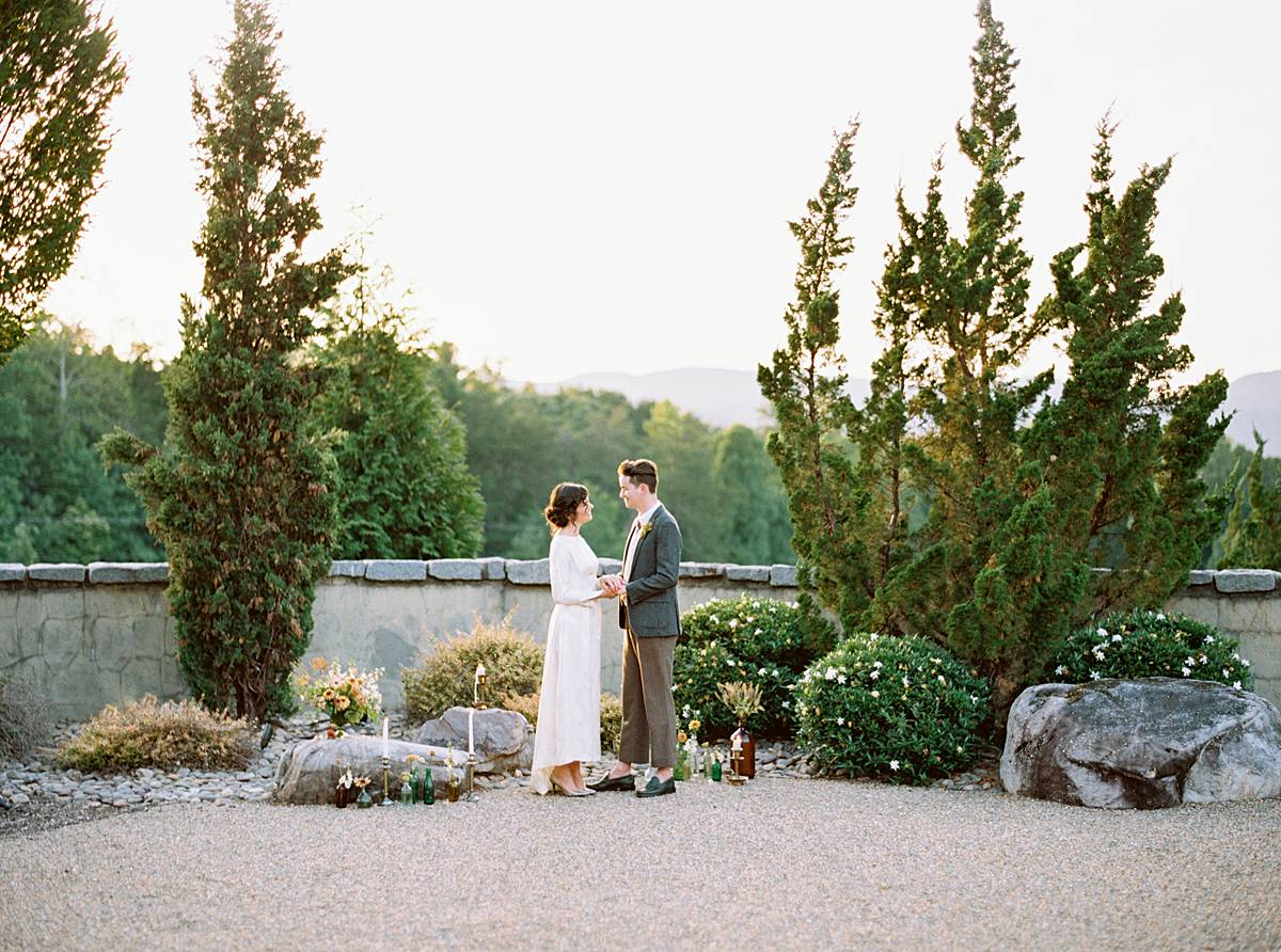 blue ridge mountains backdrop with hotel domestique intimate wedding and elopement ceremony with couple in vintage wedding gown and suit