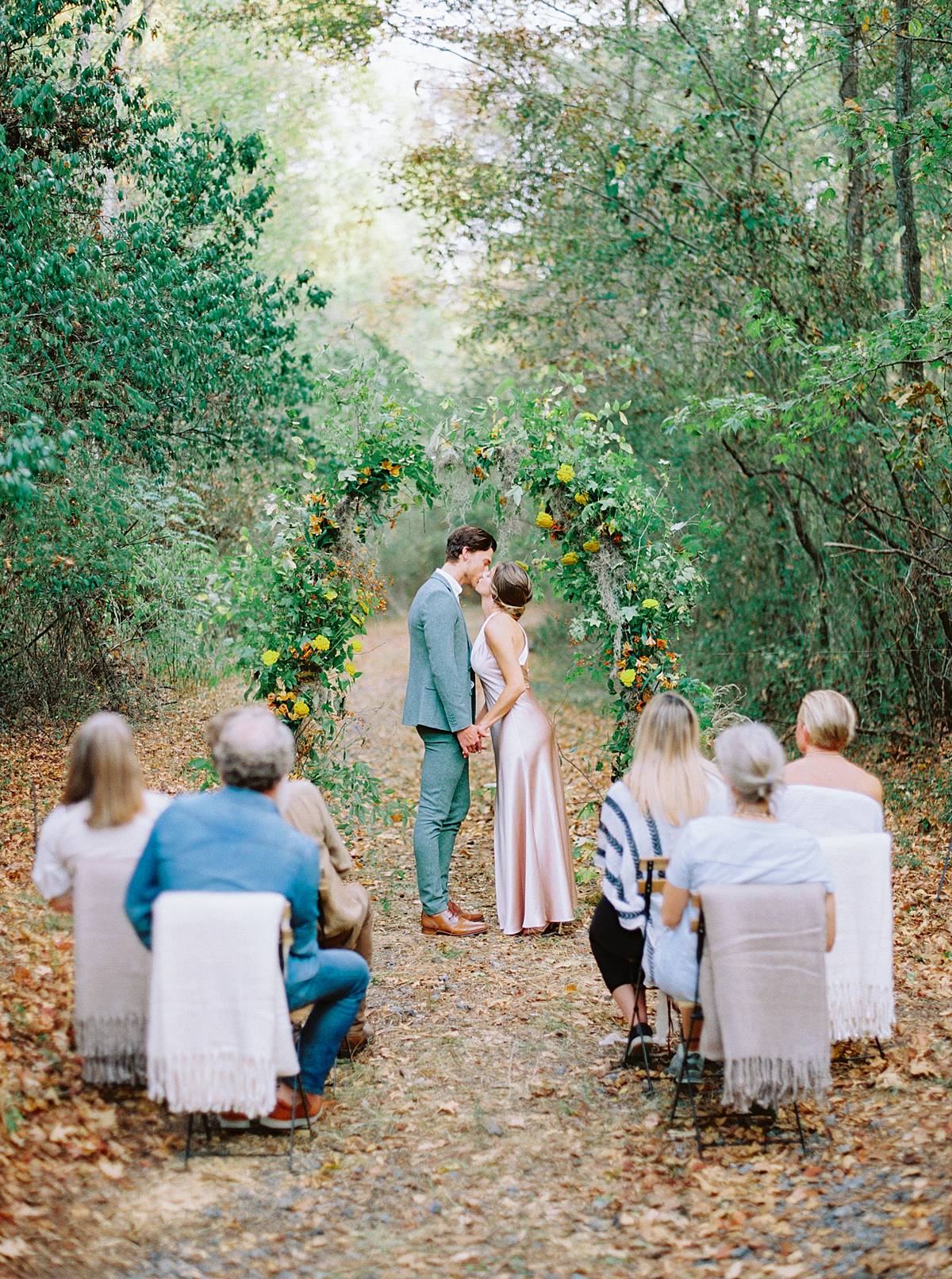 micro wedding ceremony at south carolina wavering place wedding venue groom in green tux bride in blush dress