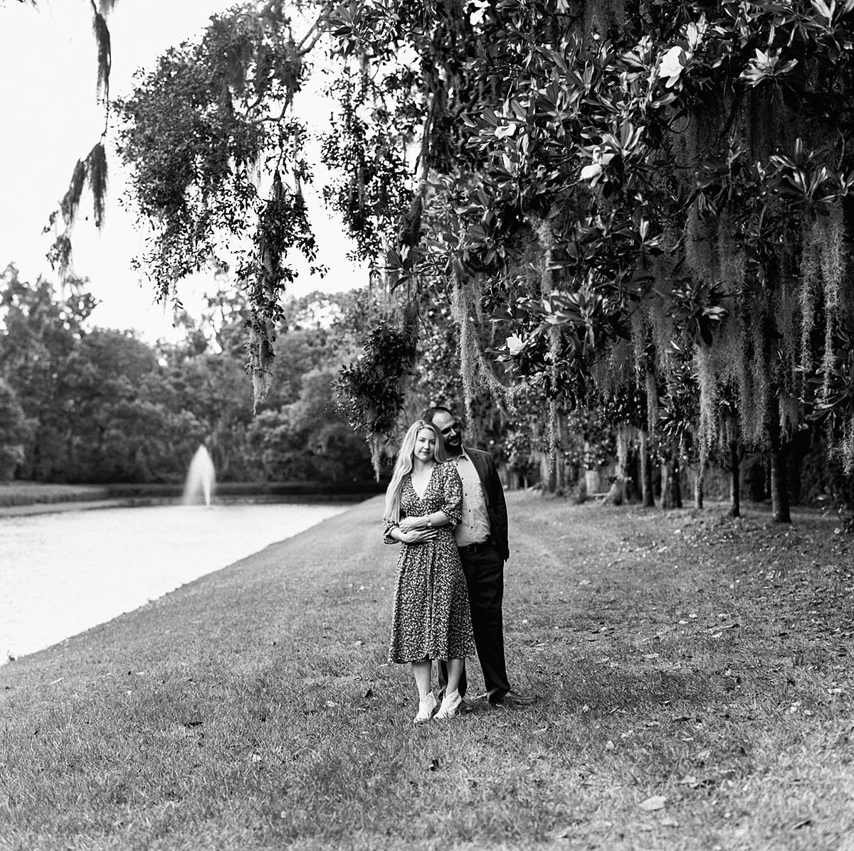 black and white portrait of couple during engagement session on kodak film at middleton place in charleston sc