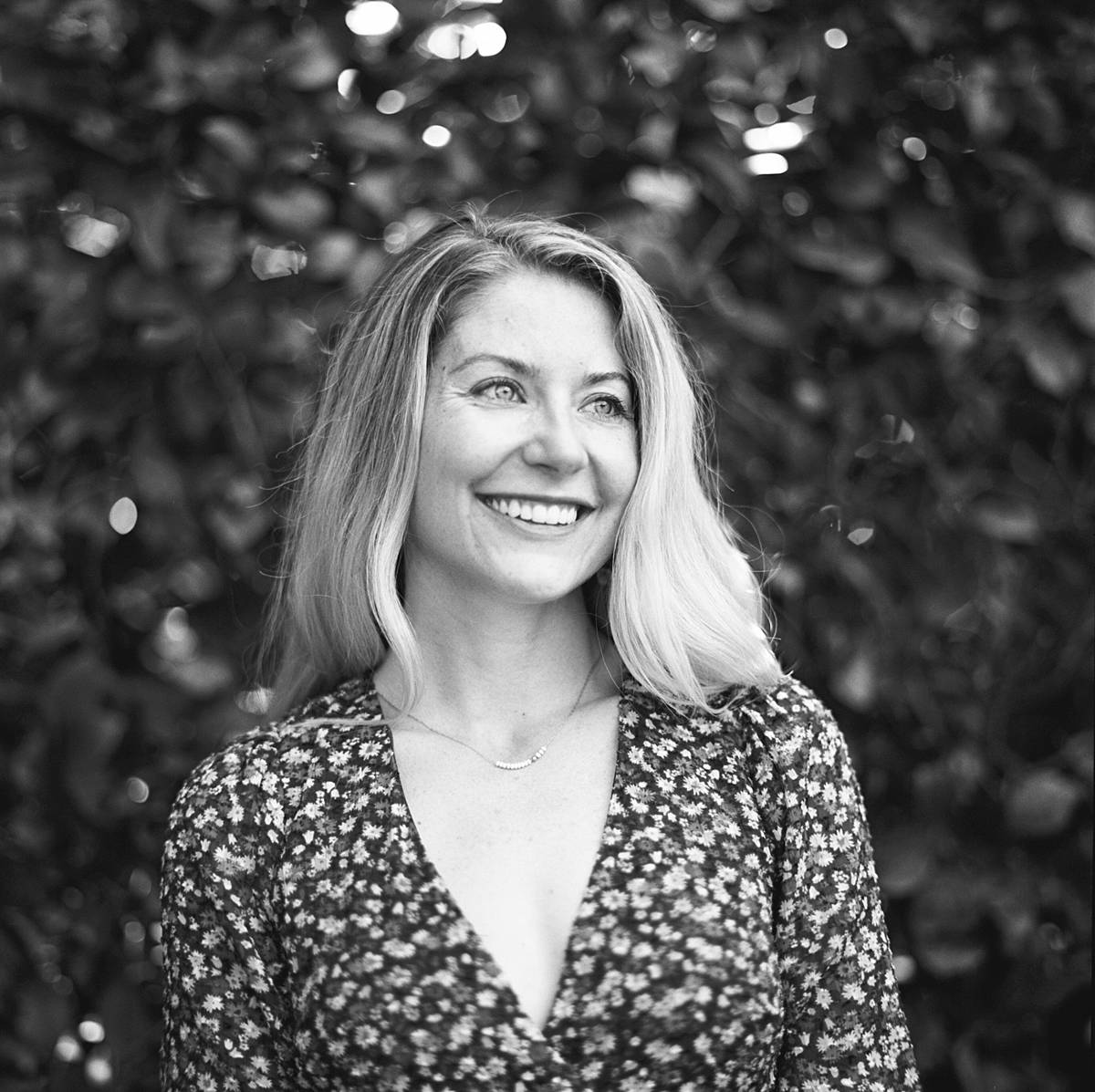 black and white portrait of a bride on engagement session on kodak tmax 400 film with crazy bokeh