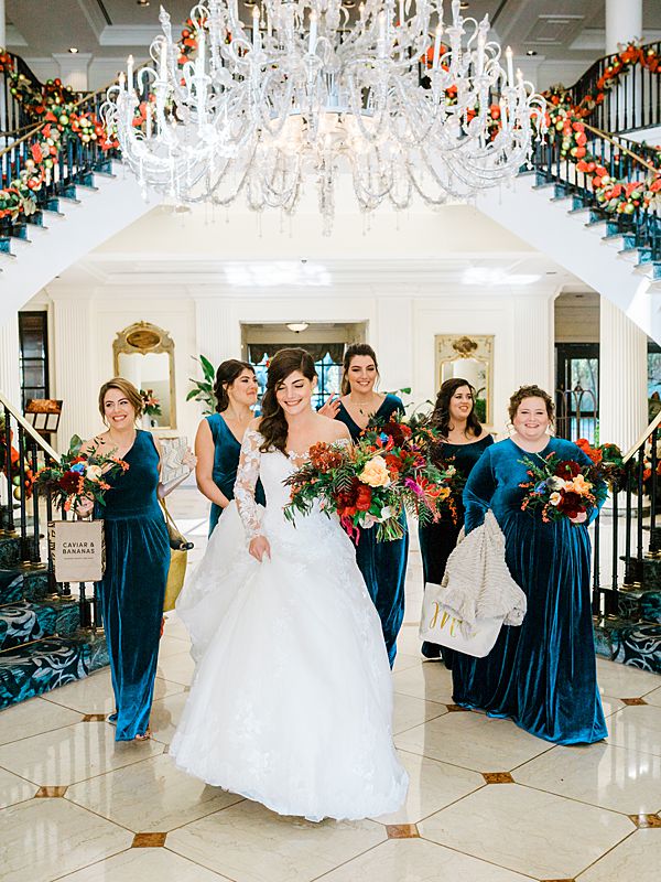 charleston wedding bridal party walking through the belmond charleston place hotel lobby