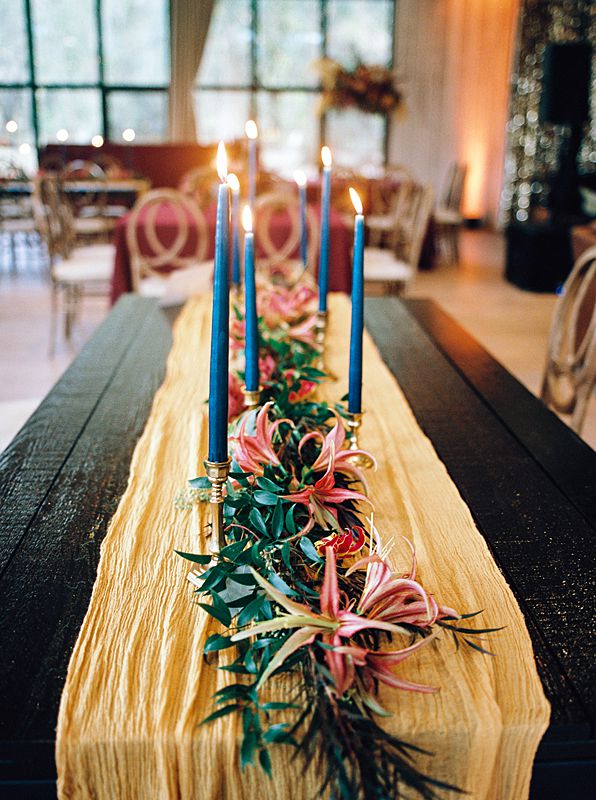 jewel tone florals and candles on reception dinner table at middleton place pavaillion in charleston south carolina