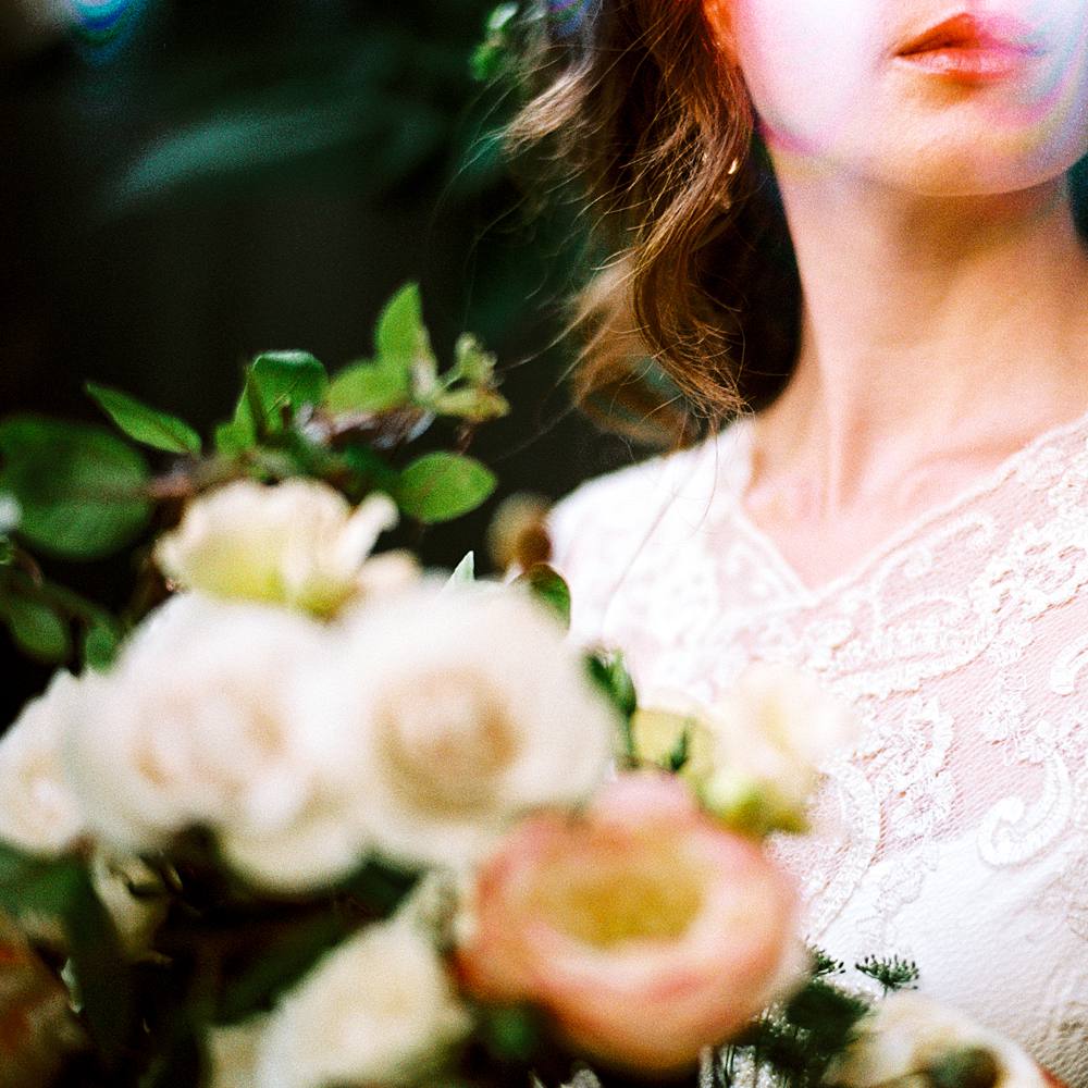 like leak 35mm film bridal portrait on kodak portra 400 film with close up red lipstich and bridal bouquet shot on leica m-a