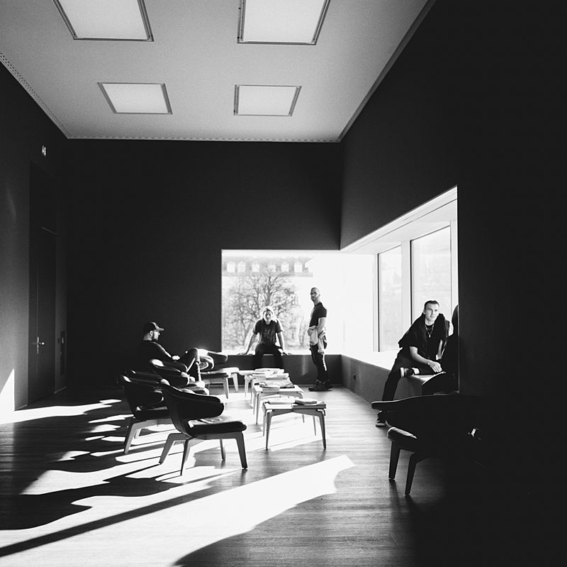 black and white film portrait of 3 friends in munich industrial modern art museum