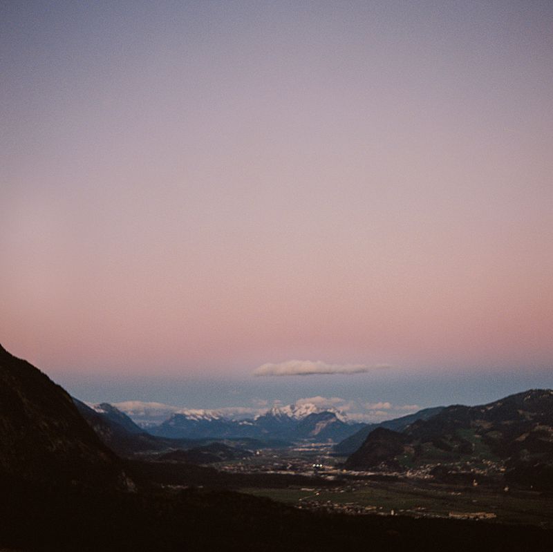 single cloud hovering over austrian valley with pink and blue cotton candy sky on kodak portra 800 medium format film