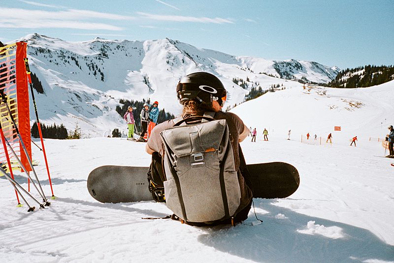 oakley ski goggles on snowboarder sitting on mountain in Kitzbuhel austria captured on 35mm film