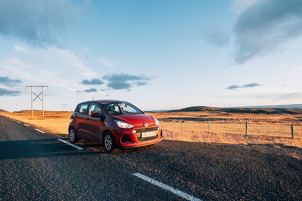 red hyundai i10 in iceland ring road during novemeber with fuji xt2