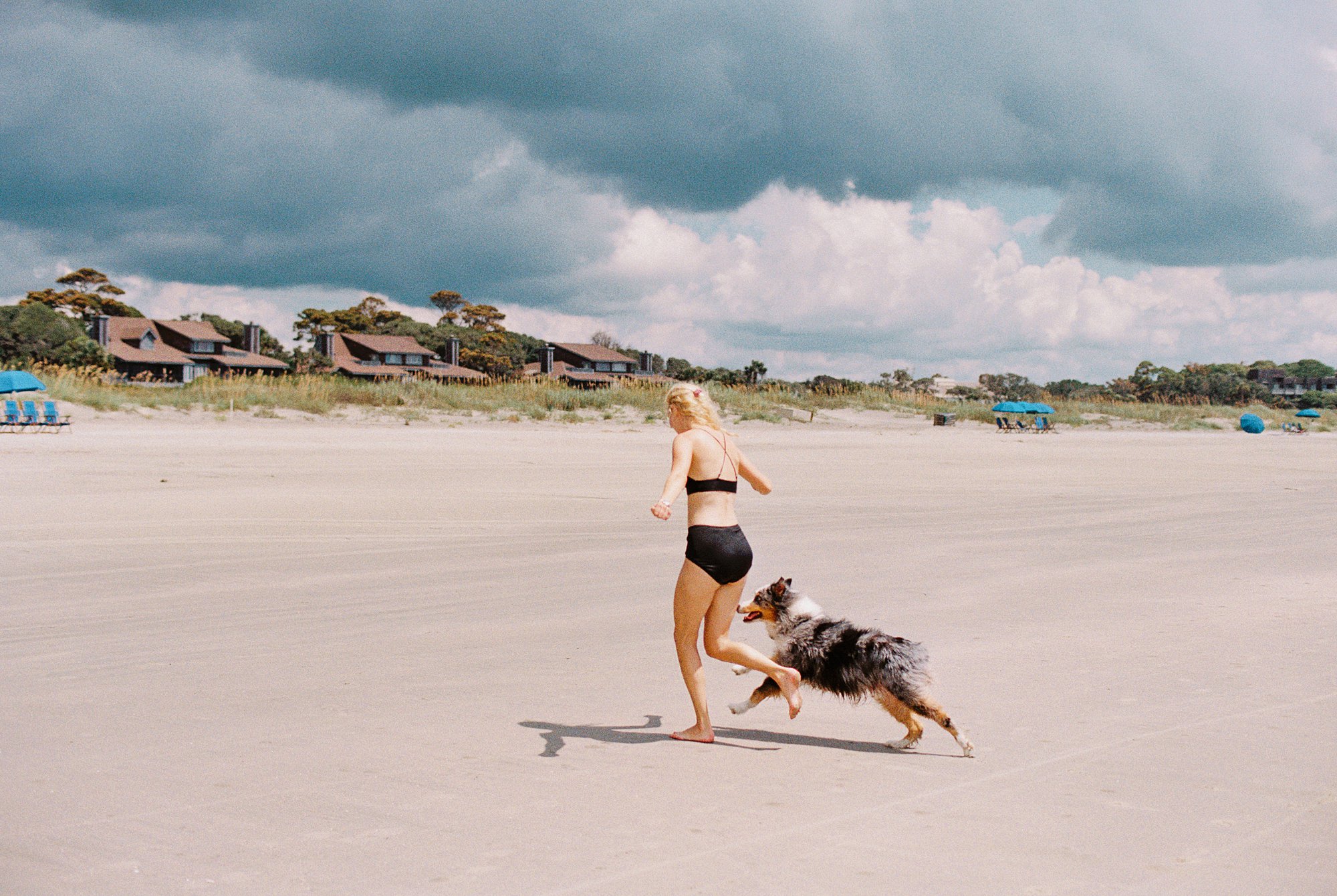 nikon fm3a and kodak gold 200 35mm film portrait of girl and dog running on kiawah island beach